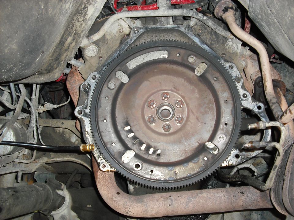 the flexplate and dust sheild get removed for the new manual trans ones, but first an oil pan swap and rear main seal