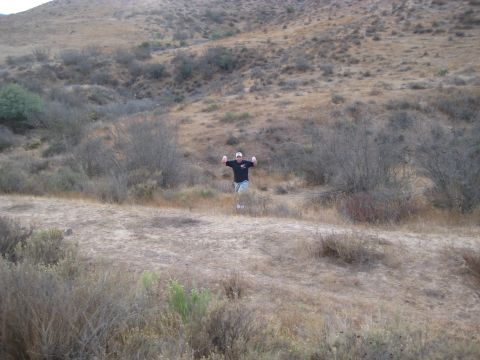 1996 Ford Bronco - Man poses in a dry, hilly landscape with sparse vegetation.