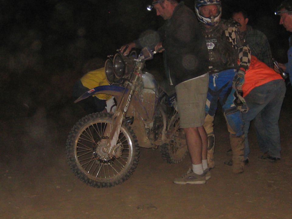Dirt bike with dual headlights and mud-covered tires