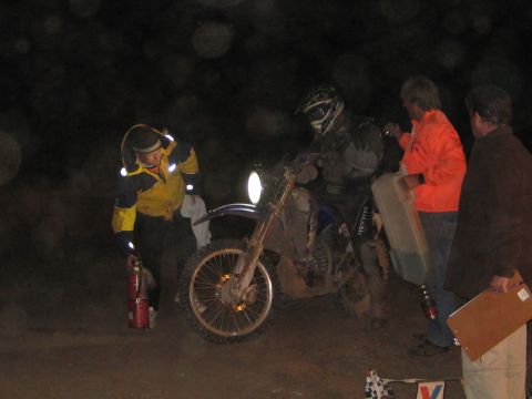 1996 Ford Bronco - People attend to a dirt bike at night, possibly during a race or event.