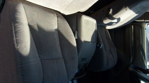 1995 Ford Bronco - Close-up of the interior, showing the front seats and center console. A Ford logo is visible on the steering wheel.