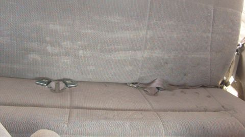 1995 Ford Bronco - Interior view of rear seats and seatbelts in a vehicle.