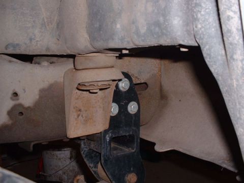 1983 Ford Bronco - Detail of a vehicle's frame and suspension mounting bracket.