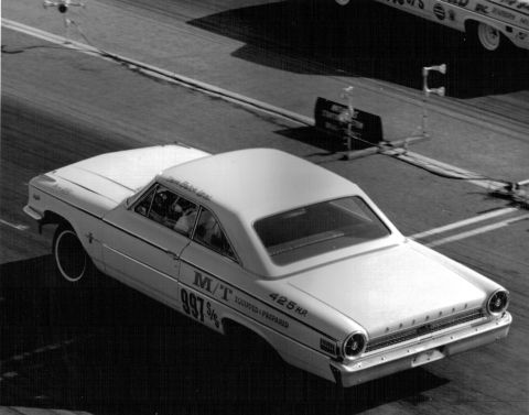 1963 Ford Galaxie - A 1963 Ford Galaxie races down the drag strip, showing its side profile and racing decals.