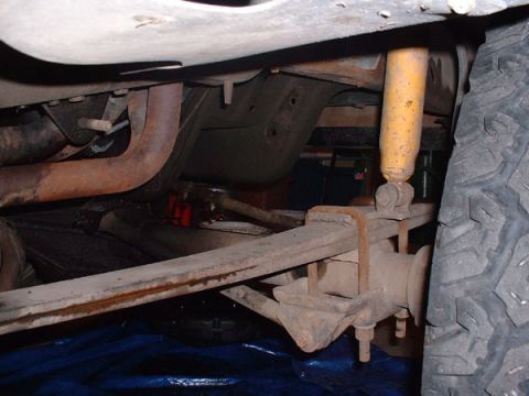 1983 Ford Bronco - Close-up view of the rear axle and suspension system of an unidentified vehicle.