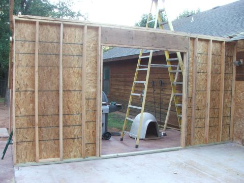2005 Ford Mustang - Construction is underway on a new building, with tools and a dog house staged nearby.