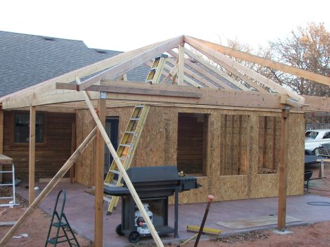 2005 Ford Mustang - Building addition under construction with a grill and ladder visible on the patio.