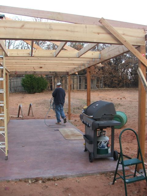 2005 Ford Mustang - Construction is underway for a new patio cover, with a grill and ladder nearby.