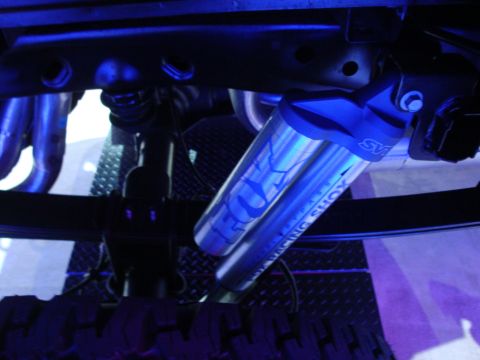 1993 Ford Taurus - Close-up view of a Fox Racing Shox component, illuminated by blue lighting.
