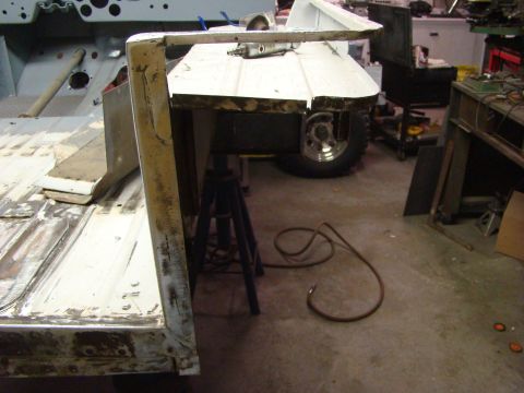1948 Jeep Wrangler - Body panel repair in progress on a Jeep CJ-5, with tools visible.