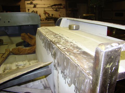 1948 Jeep Wrangler - Vehicle body undergoing repair work, with metal surfaces showing signs of sanding and preparation.