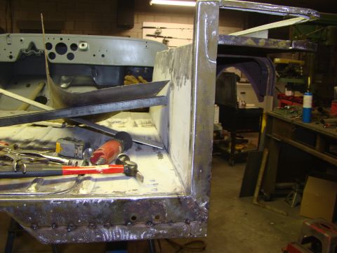 1948 Jeep Wrangler - This vehicle body panel shows signs of repair and welding, with tools scattered around the workspace.