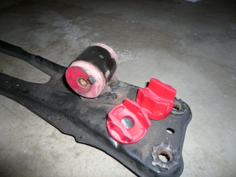 1993 Ford Probe - Aftermarket suspension bushings are shown resting on a vehicle's control arm.