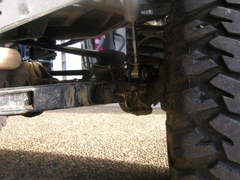 1972 Ford Bronco - Undercarriage view showing the rear axle, shock absorber, and tire tread.