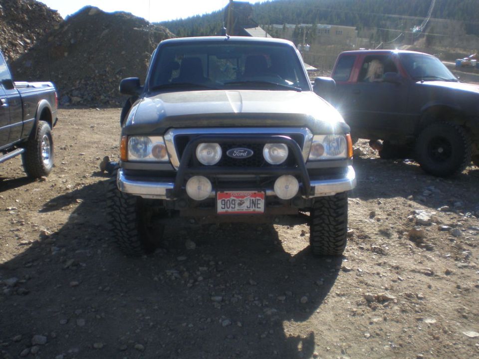 Front view of a gray Ford Ranger pickup truck with a bull bar and fog lights