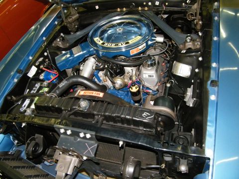 1968 Ford Mustang - The engine bay of a blue vehicle, showing the 302-4V air cleaner and other engine components.