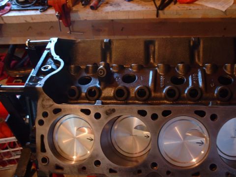 1983 Ford Bronco - Close-up view of an engine block's cylinder bores and pistons, with visible machining marks and casting details.