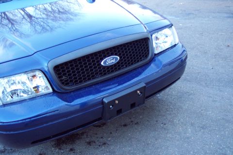 2001 Ford Crown Victoria - Front view of a blue 2001 Ford Crown Victoria, showing the grille and headlights.