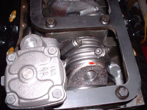 1983 Ford Bronco - Close-up view of an engine's oil pump and associated parts during assembly or repair.