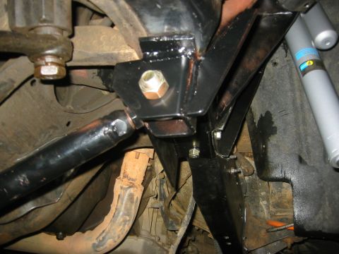 1995 Ford Bronco - Underside view of vehicle suspension components and a shock absorber.