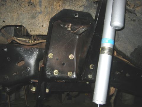 1995 Ford Bronco - Detail of vehicle suspension system, including a Bilstein shock absorber and frame components.