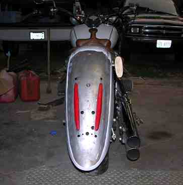 2006 Yamaha V Star Classic - A motorcycle's rear fender is shown, with a car visible in the background.