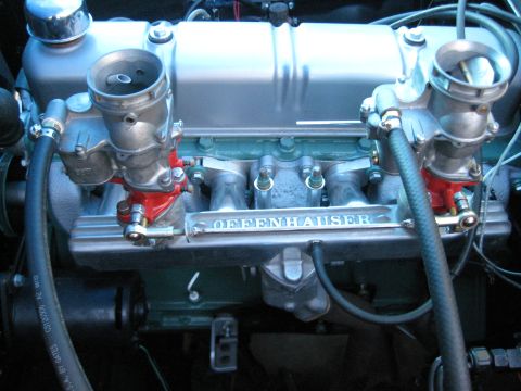 1953 Ford Mainline - Close-up of an engine's intake manifold, identified as Offenhauser, with dual carburetors.