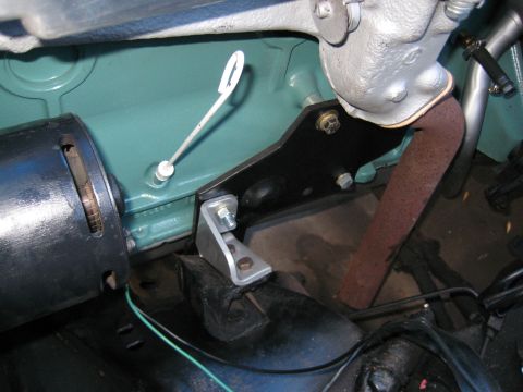 1953 Ford Mainline - Detail shot of engine components including a dipstick and exhaust pipe, with visible mounting hardware.