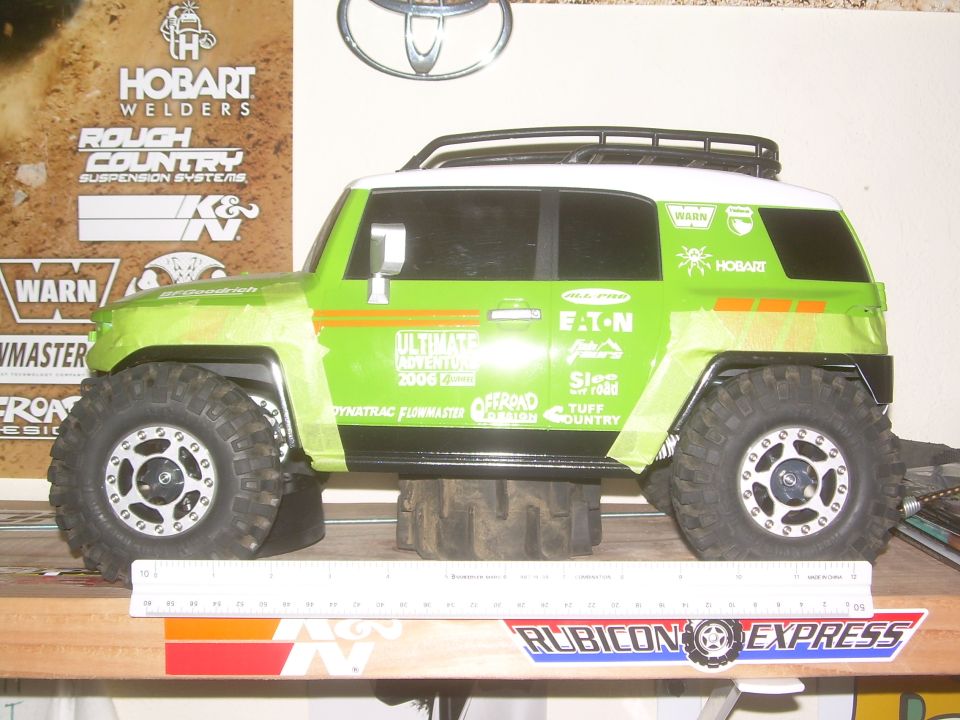 Green toy off-road vehicle with white roof and racing decals