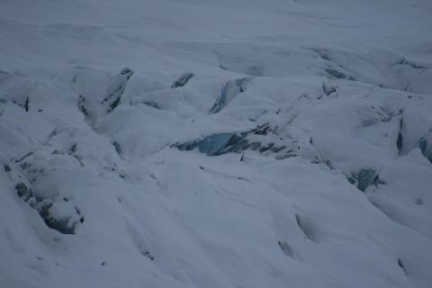 1990 Chevrolet Suburban - A vast, snow-covered glacier landscape displays numerous deep crevasses, revealing hints of blue ice within.