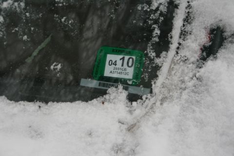 1990 Chevrolet Suburban - A snow-covered windshield displays an expired inspection sticker.
