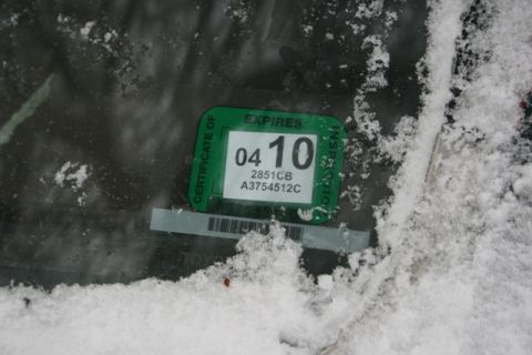 1990 Chevrolet Suburban - A close-up of a vehicle inspection sticker, partially obscured by snow, shows an expiration date of April 2010.