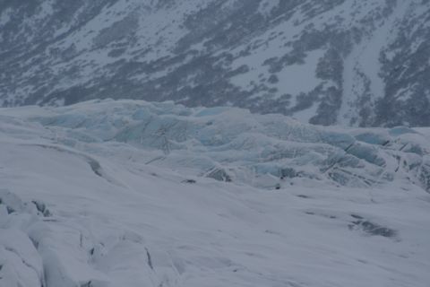 1990 Chevrolet Suburban - A vast expanse of a glacier with textured ice and snow under a muted sky.