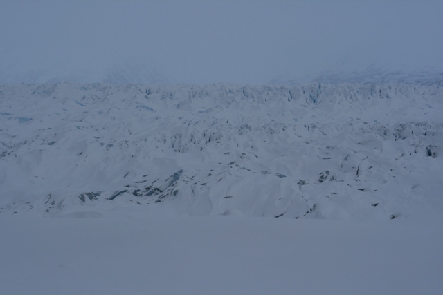 Snowy mountain range under a hazy sky