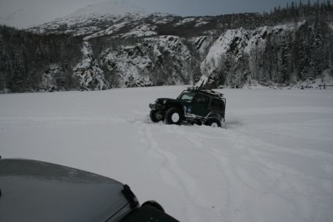 1990 Chevrolet Suburban - Off-roading in a snowy landscape with a Jeep Wrangler navigating deep snow.