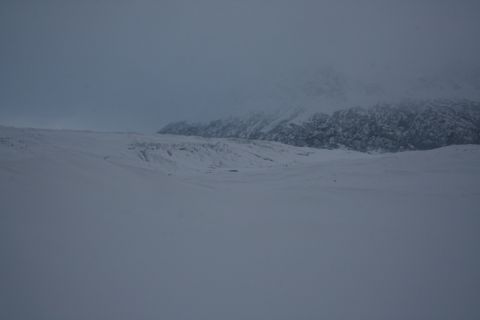 1990 Chevrolet Suburban - Expansive view of a snow-covered terrain with distant, mountains shrouded in mist.