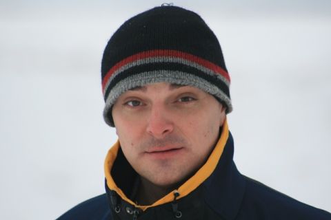 1990 Chevrolet Suburban - A man is pictured wearing winter clothing against a blurred, snowy background.