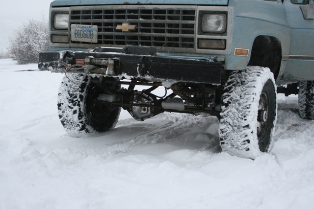 Light blue 1990 Chevrolet Suburban front end with snow-covered tires and winch