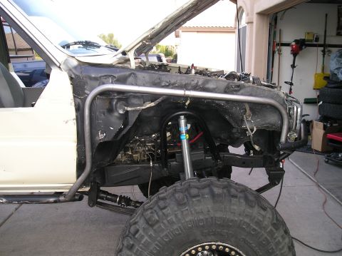 1986 Toyota Hilux - This vehicle appears to be undergoing modifications, with the front end disassembled and a roll cage installed.