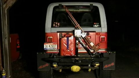 1989 Jeep YJ - Rear view of a 1989 Jeep YJ equipped with a swing away tire carrier, Hi-Lift jack, and auxiliary fuel can.