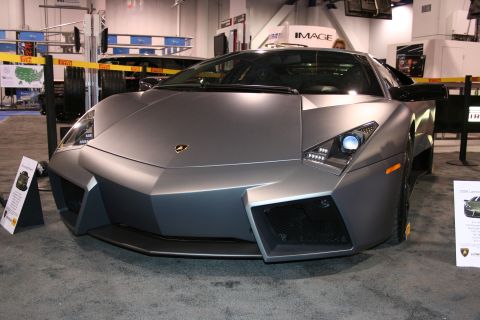 Matte gray Lamborghini Reventon front view, angled left, with visible headlights and grille