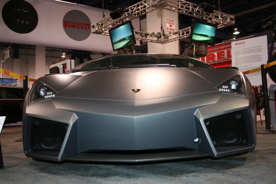 Matte gray supercar front view with angular design and LED headlights