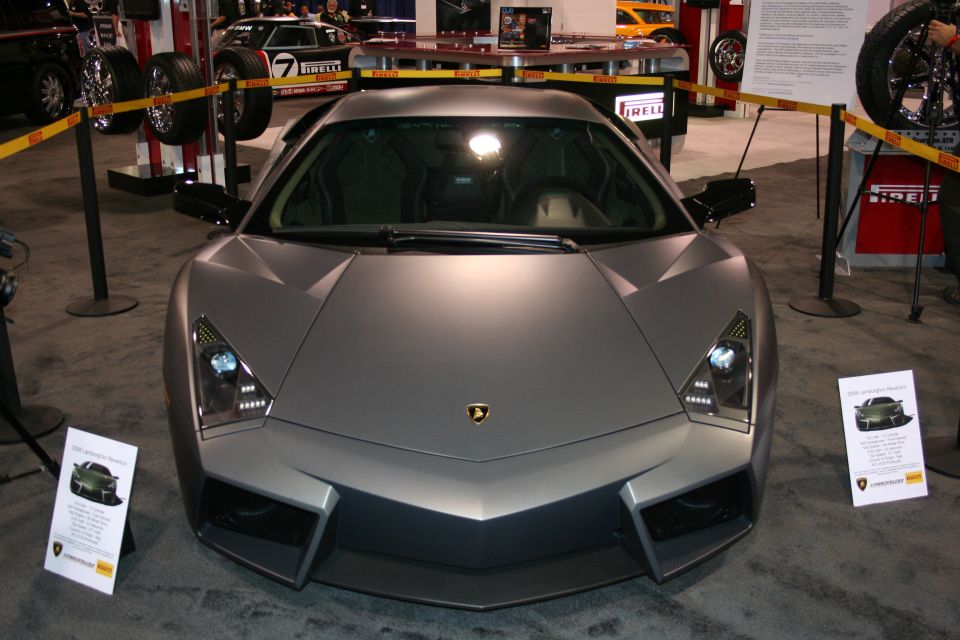 Matte gray Lamborghini Reventon front view with a display sign showing "2008 Lamborghini Reventon"