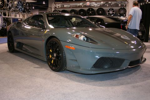 Gray Ferrari coupe with black wheels and yellow brake calipers