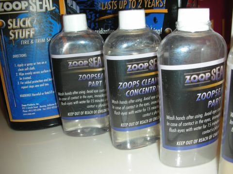 1998 Ford Crown Victoria - Several bottles of car cleaning products are displayed, with labels indicating different uses like tire shine and concentrate.
