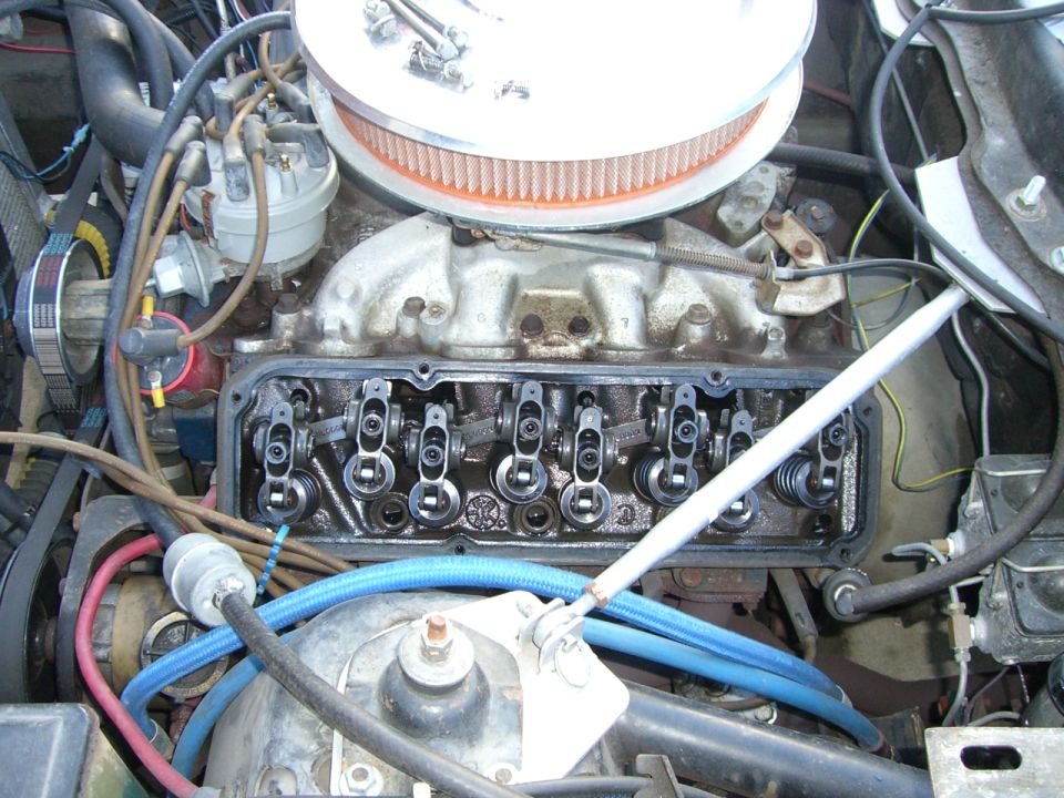 Engine bay with valve covers removed showing rocker arms and intake manifold