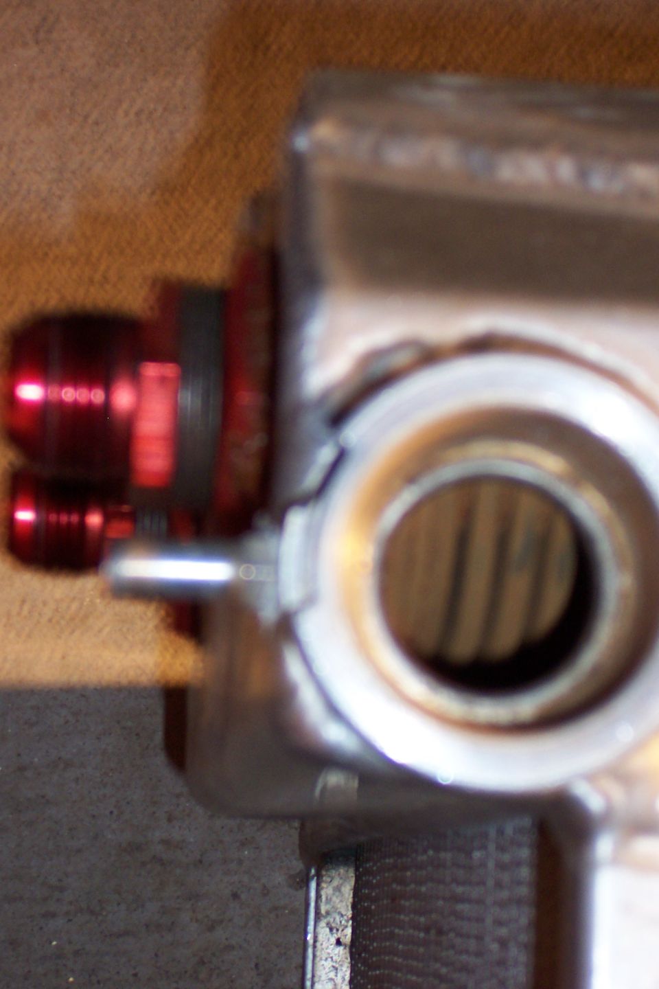 Close-up of a radiator part with red AN fittings attached