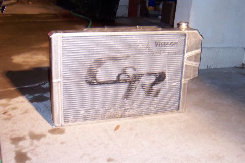 1971 Ford Mustang - A C&R branded aluminum radiator sits on a concrete surface.