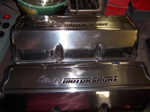 1971 Ford Mustang - Polished aluminum Ford Motorsport valve covers are shown stacked on a workbench.