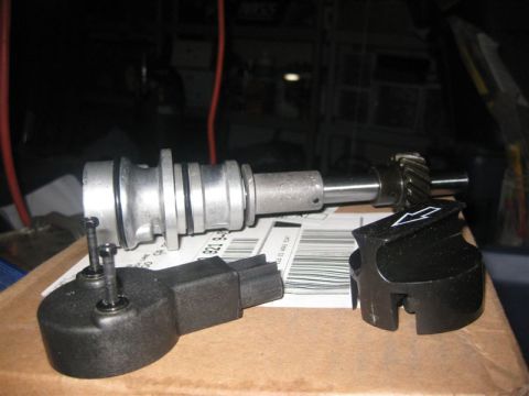 1971 Ford Mustang - Automotive distributor and rotor components are laid out on a surface with visible barcode labels.